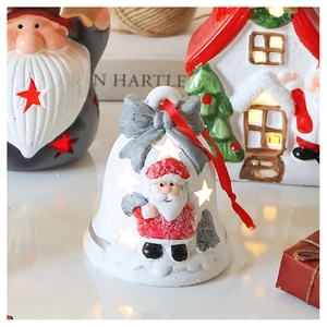 Detail of Santa Claus bell ornament with star cutouts and festive warm lighting effect
