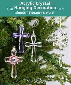 Detailed view of clear acrylic crystal cross and snowflake ornaments on Christmas tree