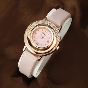 Detail of pink PU leather strap and gold quartz watch bezel with sparkling rhinestones