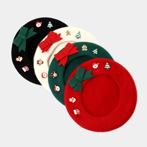 Detail of wool berets with festive Christmas cartoon patches and decorative bows