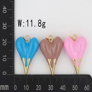 Detailed view of heart enamel pendants in blue, pink, and brown with scale measurement