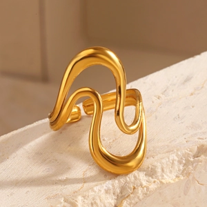 Minimalist 18K gold plated stainless steel wave ring on a natural stone background