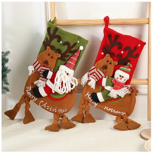 Detail of plush Christmas stockings with 3D Santa and Reindeer on a wooden ladder