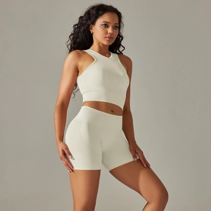 Detail of high-stretch seamless knit sports set in cream white showing ribbed texture