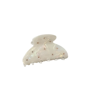 Elegant cream white pearlescent hair claw clip with star-patterned sparkling rhinestones