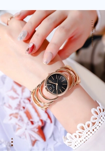 Close-up of Gedi rose gold hollow bracelet watch with a minimalist black dial on wrist