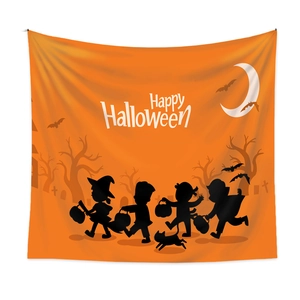Detail of vibrant orange Halloween tapestry featuring kids silhouette and Happy Halloween text