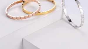 Detailed scale texture design on metal bracelets in gold, rose gold and silver finishes