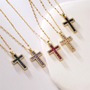 Close-up of gold cross necklaces with colorful square zircon center stones in five shades