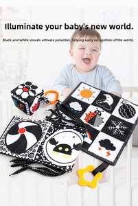 Close-up of baby cloth book with black and white patterns and a yellow star teether toy