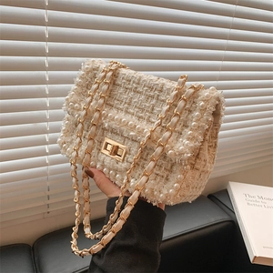 Elegant white tweed chain crossbody bag with pearl trim and golden turn-lock closure