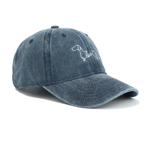Close-up of dog and love embroidery on washed dark blue denim cotton baseball cap