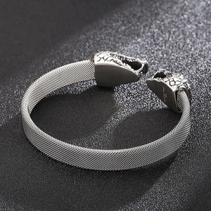 Macro shot of 316L stainless steel mesh band with intricate snake head engraving