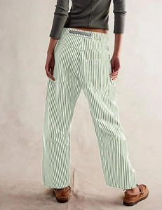 Detail of green and white vertical striped wide-leg pants with rear pockets and drawstring