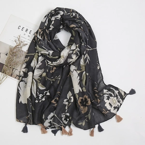 Close-up of floral print linen scarf with dual-tone fringe tassels and soft texture