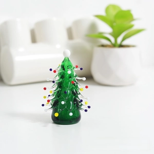 Macro shot of handcrafted glass mini Christmas tree ornament with colorful dot accents