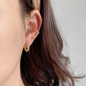 Detailed view of gold S925 sterling silver ear cuffs with textured hammered finish