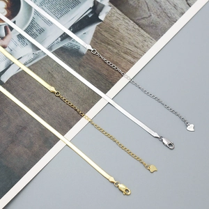 Detail view of gold and silver S925 sterling silver snake chains with lobster clasps