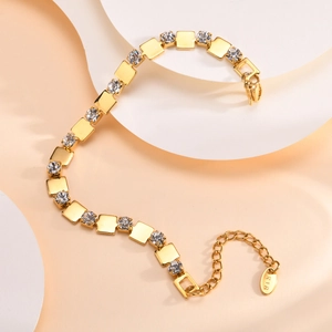 Detailed macro view of 18K gold plated chain with zircon stones and K18 hallmark stamp
