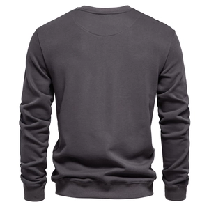 Detail view of the back of a dark gray crewneck sweatshirt with knit fabric texture