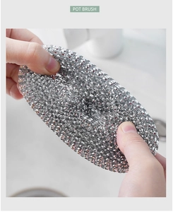 Close-up of flexible silver wire mesh ball for pot cleaning brush in kitchen sink