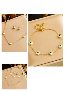 Detailed view of gold stainless steel Turkish evil eye necklace, bracelet, and earring set