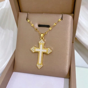 Elegant gold titanium cross necklace with white shell inlay and sparkling crystals