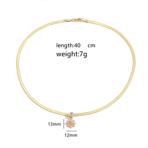 Detailed view of pink daisy pendant on gold snake chain with dimensions and weight