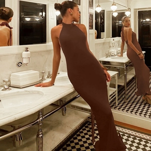 Detail of elegant backless halter neck dress in coffee brown with ruffle hem texture