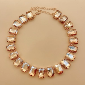 Detail of amber crystal necklace with rectangular facets in golden claw settings