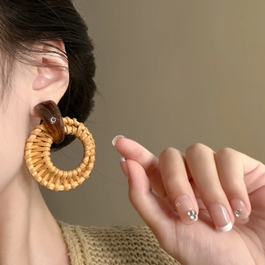 Bohemian geometric round rattan drop earrings with wood resin splice on model