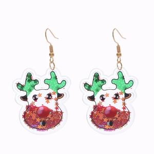 Macro detail of reindeer Christmas earrings with festive red and orange star sequins