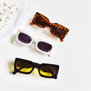 Three retro rectangle sunglasses in leopard print, white, and black with colored lenses