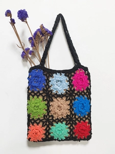 Detailed close-up of handmade crochet tote bag featuring multi-color floral patchwork squares