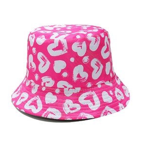 Detail of rose pink bucket hat with white hand-drawn heart prints and smooth texture