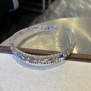Macro detail of luxury baroque crystal headband with multi-colored rhinestones on clear base