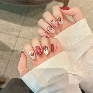 Handmade 2D anime style press-on nails in deep red and champagne glitter designs