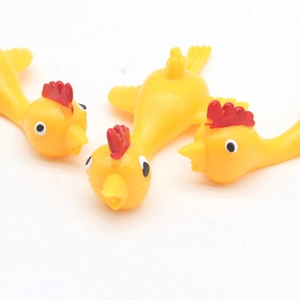 Three yellow rubber chickens with red combs on a white background for stress relief