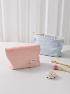 Pink and blue checkered cosmetic bags with zippers for travel and skincare storage