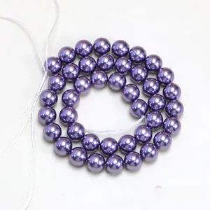 Macro shot of high-luster deep purple round faux pearls for DIY jewelry making