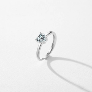 Minimalist S925 sterling silver open ring with a heart-shaped zircon stone on white background