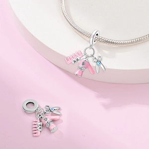 Detailed pink enamel hair tool charms with scissors and comb on silver plated bracelet
