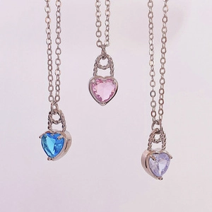 Three heart lock necklaces with blue, pink, and purple gemstones in vertical display
