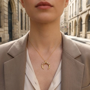 Fashionable horn necklace with micro-set zircon in gold finish worn by a model