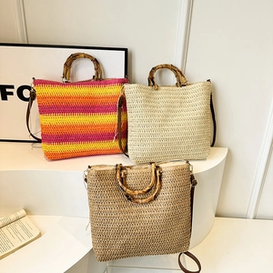 Three straw beach tote bags with bamboo handles in striped, beige, and brown colors