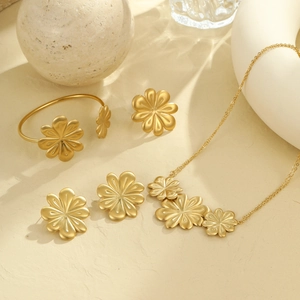 Brushed gold stainless steel floral jewelry set including necklace, bracelet, and earrings