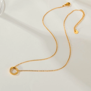 Close-up of golden geometric ring pendant with sparkling zircons and adjustable lobster clasp
