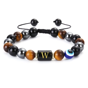 Detailed view of handmade tiger eye beads and evil eye charm on an adjustable bracelet