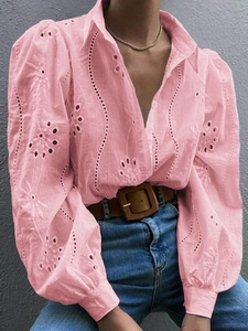 Close-up of pink puff sleeves featuring intricate embroidery and hollow-out lace details
