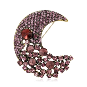 Elegant gold-tone crescent moon brooch adorned with sparkling purple rhinestones